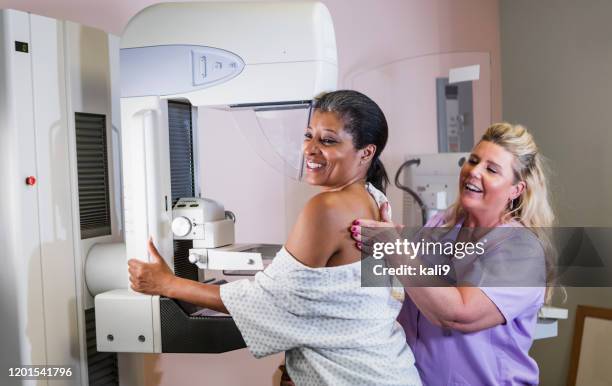 african-american woman getting a mammogram - radiographer stock pictures, royalty-free photos & images