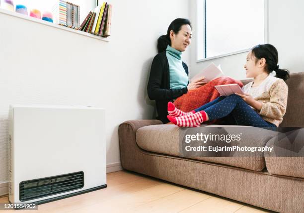 mother and daughter having a good time in a bright warm room - japanese girls hot fotografías e imágenes de stock