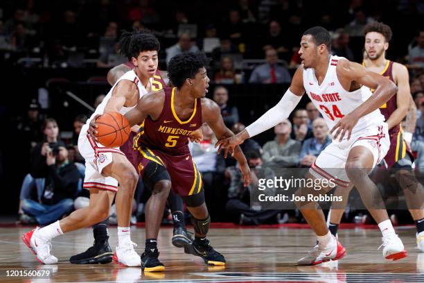 Marcus Carr of the Minnesota Golden Gophers handles the ball against D.J. Carton and Kaleb Wesson of the Ohio State Buckeyes in the first half of the...