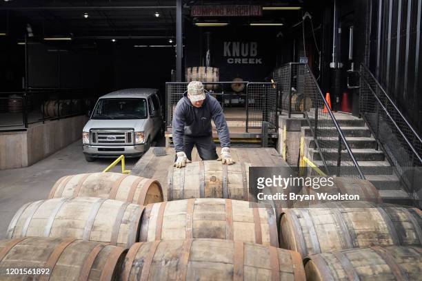 Workers move barrels of bourbon at The Jim Beam Distillery on February 17, 2020 in Clermont, Kentucky. U.S. Whiskey exports have fallen by 27 percent...