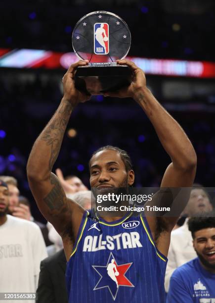 Kawhi Leonard of Team LeBron hoists the NBA All-Star Game Kobe Bryant MVP Award following the NBA All-Star Game on Sunday, Feb. 16, 2020 at the...