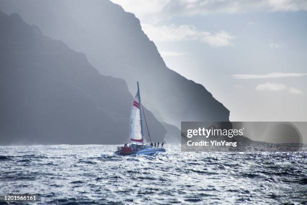 mysterious misty na pali coast and waimea canyon, kauai, hawaii - catamaran sailing stock pictures, royalty-free photos & images