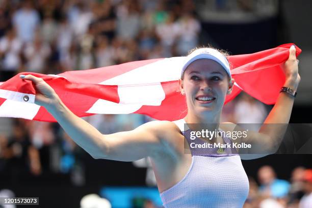 Caroline Wozniacki of Denmark drapes a Danish flag over her shoulders and acknowledges the crowd after losing her Women's Singles third round match...