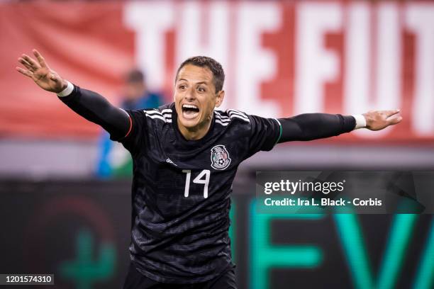Javier Hernandez of Mexico holds his arms outstretched to celebrate a goal during the second half of the Friendly match between the United States...