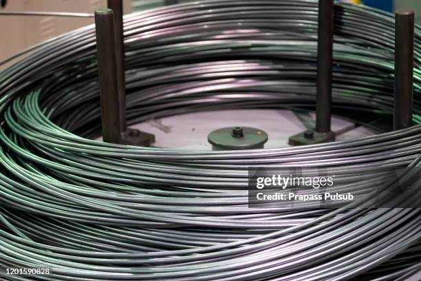 industrial warehouse with rolls of steel sheet in a plant galvanized steel coil - galvanized stock pictures, royalty-free photos & images