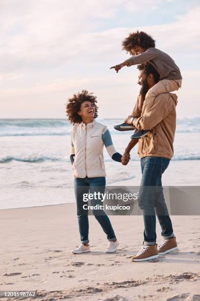 the family who spends time together grows together - boy exploring on beach stock pictures, royalty-free photos & images