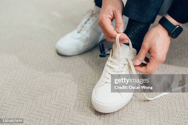 man shopping for shoes in clothing store - lacet de chaussures photos et images de collection