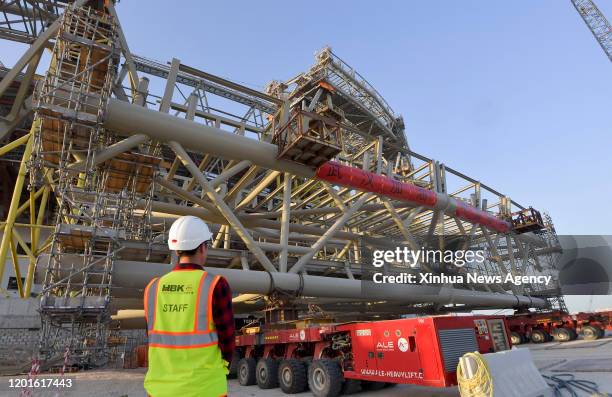 Feb. 17, 2020-- Photo taken on Feb. 16, 2020 shows banners reading ""Wuhan be strong" and "China keep going" at the construction site of the Lusail...