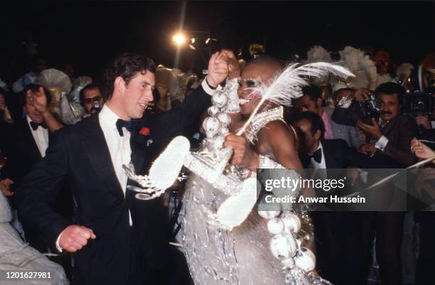 Prince Charles, Prince of Wales dances with a Samba dancer at a party at the Town Hall in 1978 in Rio de Janeiro, Brazil.