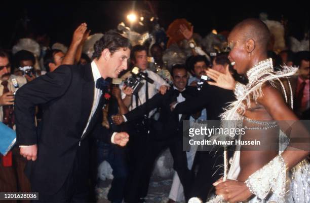 Prince Charles, Prince of Wales dances with a Samba dancer at a party at the Town Hall in 1978 in Rio de Janeiro, Brazil.