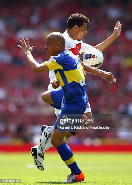 Marcos Ceara of Paris St Germain and Clemente Rodriguez of Boca Juniors battle for the ball during the Emirates Cup match between Boca Juniors and...
