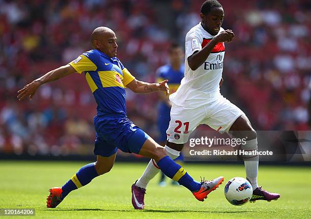 Clemente Rodriguez of Boca Juniors challenges Jean Eudes Maurice of Paris St Germain during the Emirates Cup match between Boca Juniors and Paris St...