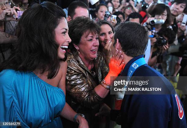 Swimmer Michael Phelps talks to his mother Debbie and girlfriend Nicole after he competed in the final of the men's 4x100 medley relay swimming event...