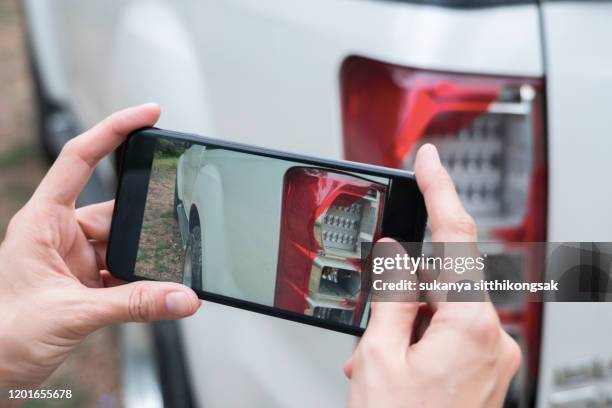 close up of hand woman take photo shattered car lights by smartphone. - accidents and disasters photos stock pictures, royalty-free photos & images