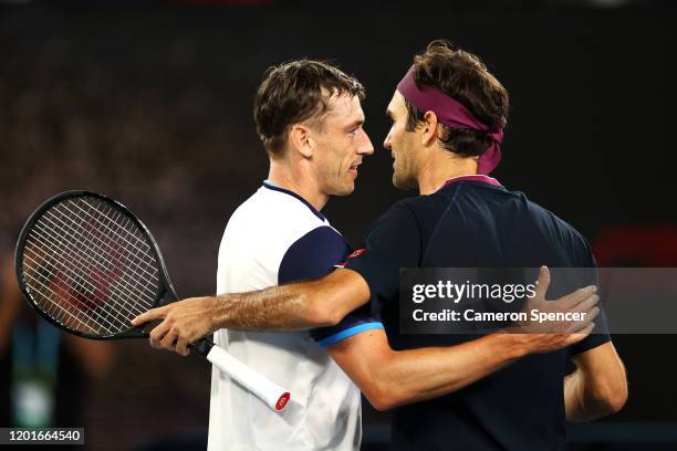 Roger Federer of Switzerland is congratulated by John Millman of Australia after winning their Men's Singles third round match on day five of the...