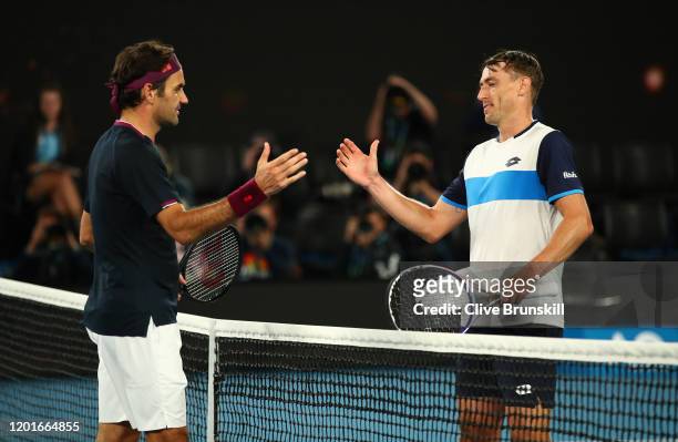 Roger Federer of Switzerland shakes hands at the net after his five set victory in his Men's Singles third round match against John Millman of...