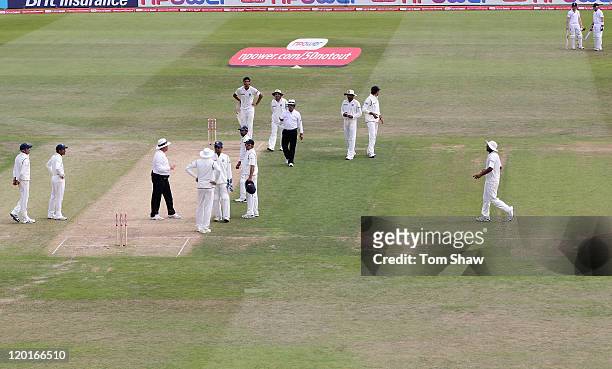 Umpire Marais Erasmus and Asaf Rauf talk to the Indian players after Ian Bell of England is controversially run out during the second npower Test...