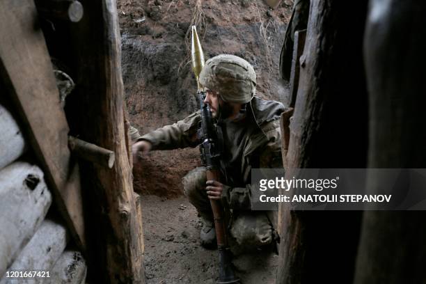 Picture taken on January 18, 2020 shows a Ukrainian serviceman at a position on the front line with Russia-backed separatists near the village of...
