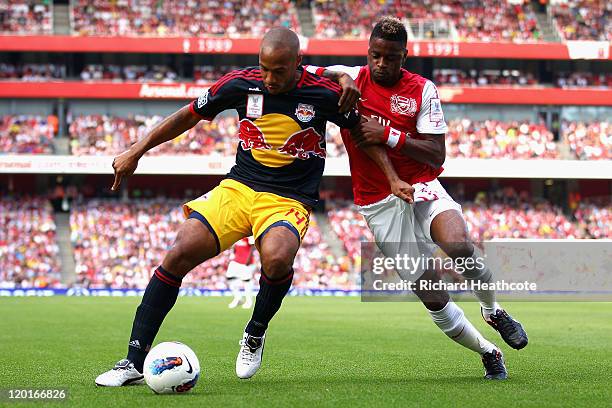 Thierry Henry of New York Red Bulls and Alex Song of Arsenal battle for the ball during the Emirates Cup match between Arsenal and New York Red Bulls...