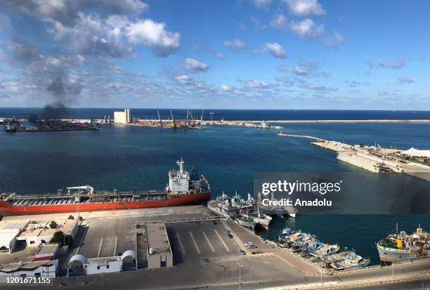 Smoke rises after warlord Khalifa Haftarâs forces launched an attack on a port near the Martyrs' Square, where celebration events marking the 9th...