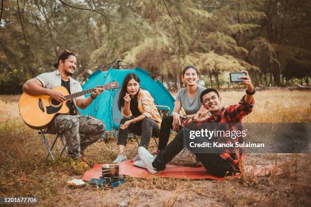 group of friend taking a selfie on a camping trip - friendship asian stock pictures, royalty-free photos & images