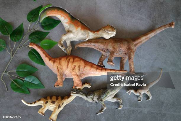 toy dinosaurs on black background - toy animal stock pictures, royalty-free photos & images