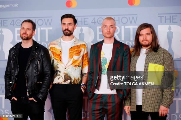 British indie pop band 'Bastille', Dan Smith, Kyle Simmons, Will Farquarson, and drummer Chris Wood pose on the red carpet on arrival for the BRIT...