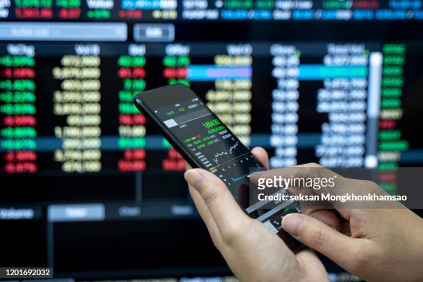 businessman checking stock market on mobile phone,stock market - forex fotografías e imágenes de stock