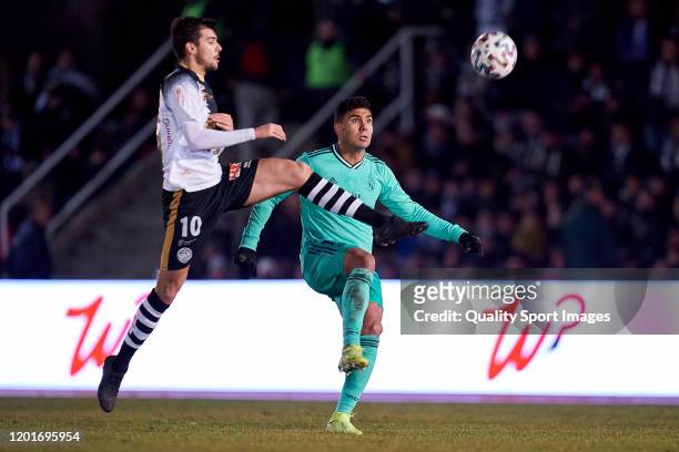 Carlos de la Nava of Unionistas CF competes for the ball with Carlos Henrique Casemiro of Real Madrid CF during the Copa del Rey round of 32 match...
