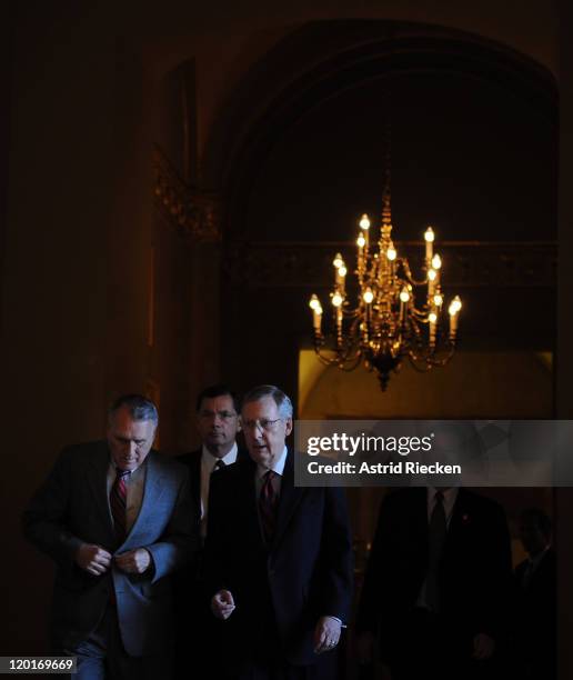 The US Senate Minority Leader Mitch McConnell and Minority Whip Jon Kyl walk to the Senate chamber for a vote at the Capitol on July 31, 2011 in...