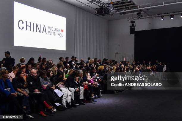Guests wait for the start of the "China, We are With You" fashion show from Chinese designer Han Wen, who is based in New York, kicking off the...