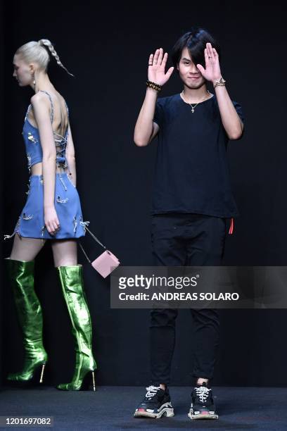 New York based Chinese designer Han Wen acknowledges applause following the presentation of his Fall - Winter 2020 collection, as part of the "China,...