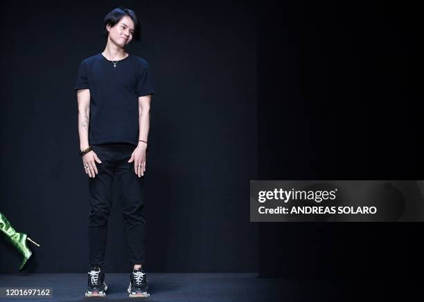 New York based Chinese designer Han Wen acknowledges applause following the presentation of his Fall - Winter 2020 collection, as part of the "China,...