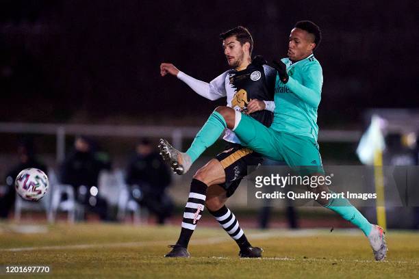 Carlos de la Nava of Unionistas CF competes for the ball with Eder Gabriel Militao of Real Madrid CF during the Copa del Rey round of 32 match...