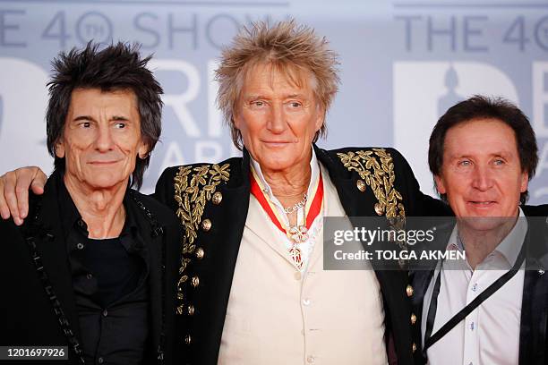 British musician Ronnie Wood , British singer Rod Stewart and British drummer for Small Faces, Faces, and the Who Kenney Jones pose on the red carpet...