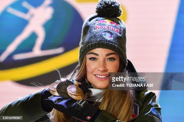 Italy's Dorothea Wierer poses with two gold medals and one silver medal she won so far, on the podium after winning the IBU Biathlon World Cup...