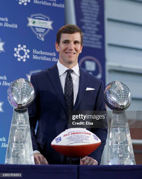 Eli Manning of the New York Giants poses with the two Super Bowl trophies after a press conference announcing his retirement on January 24, 2020 at...