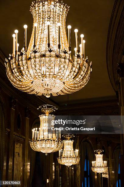 series of well lit crystal chandeliers - chandelier stock pictures, royalty-free photos & images