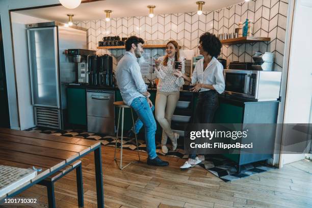 three people having a coffee break at the office. they are drinking yerba mate together. - coffee break office stock pictures, royalty-free photos & images