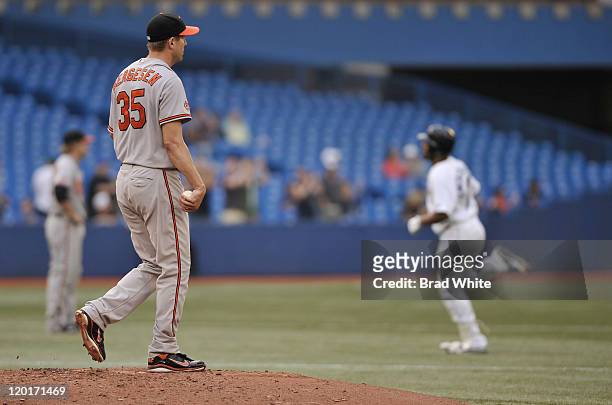 Brad Bergesen of the Baltimore Orioles looks on as Edwin Encarnacion of the Toronto Blus Jays runs the bases after hitting a home run during the game...