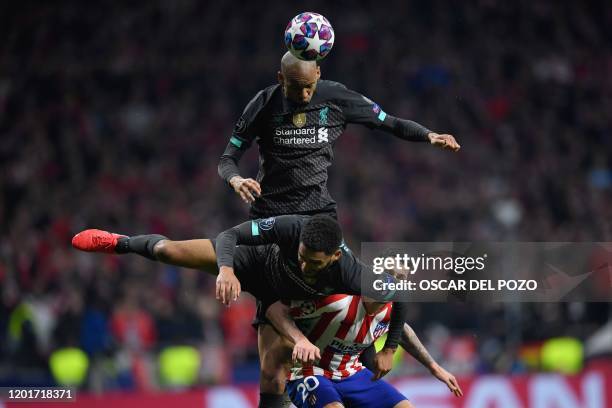 Liverpool's Brazilian midfielder Fabinho and Liverpool's English defender Joe Gomez challenge Atletico Madrid's Spanish midfielder Vitolo during the...