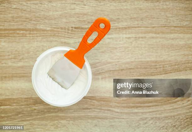 filler putty in the bucket, white plaster and spatula. repair construction stucco design concept - alabaster background stock pictures, royalty-free photos & images