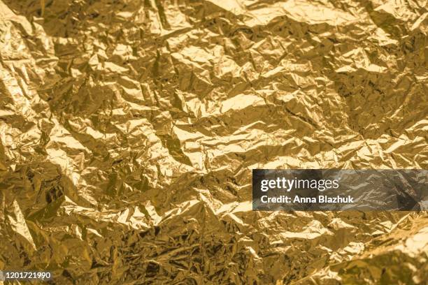 golden shiny crumpled texture for design, background - citation stock-fotos und bilder