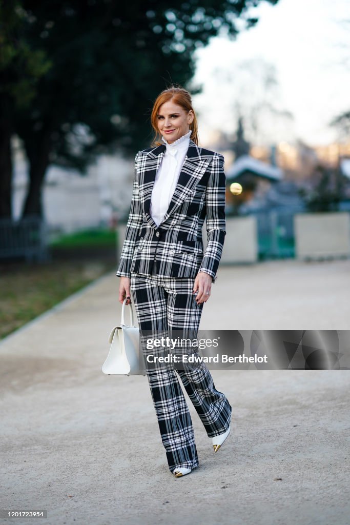Sarah Rafferty Street Actress Sarah Rafferty wears earrings, a white shirt with a pleated ...
