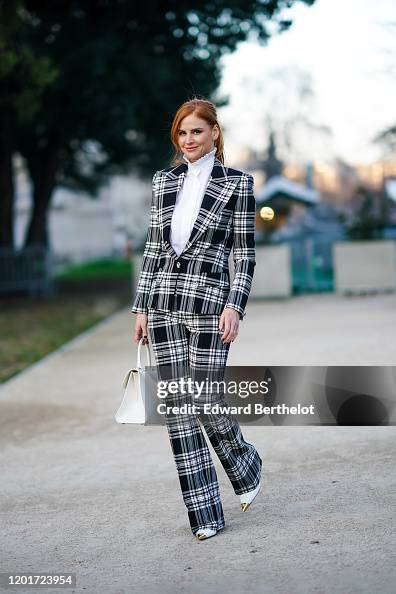 Sarah Rafferty Getty Images Actress Sarah Rafferty wears earrings, a white shirt with a pleated ...
