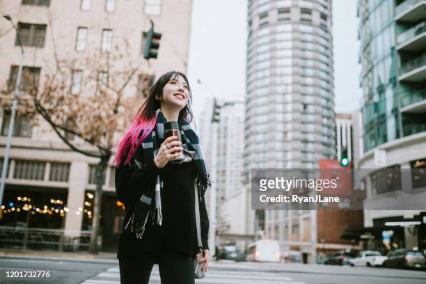 woman in overcast downtown seattle washington - seattle stock pictures, royalty-free photos & images