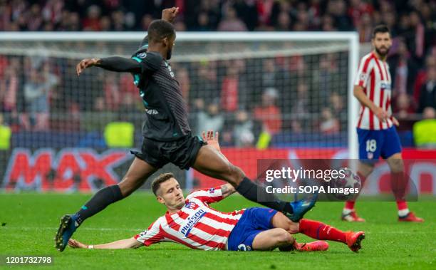 Liverpool's FC Georginio Wijnaldum and Atletico de Madrid's Saul Ñiguez are seen in action during the UEFA Champions League match, round of 16 first...