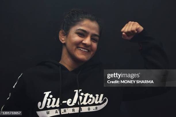 In this photograph taken on on February 12 Indian mixed martial arts fighter Ritu Phogat poses for a picture during an interview with AFP, in New...