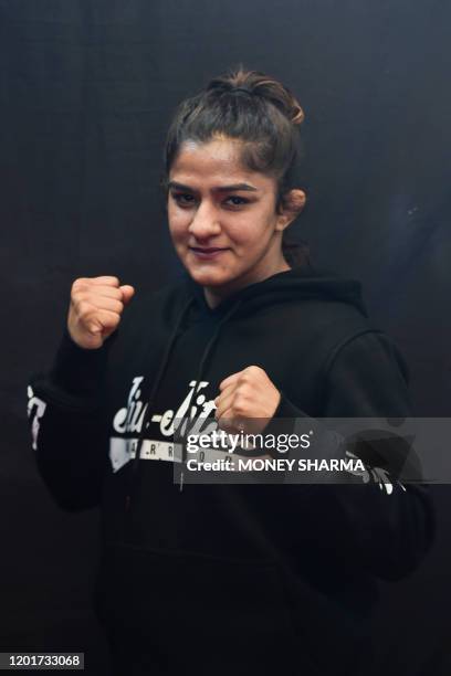 In this photograph taken on on February 12 Indian mixed martial arts fighter Ritu Phogat poses for a picture during an interview with AFP, in New...