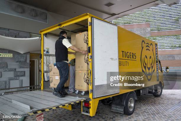 An Asia Tigers Group employee loads boxes into a truck, during a customer's relocation overseas, in Hong Kong, China, on Friday, Feb. 14, 2020. The...